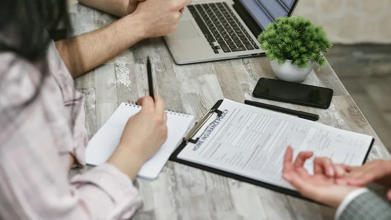 Insurance advisor using a laptop to guide a client through their options