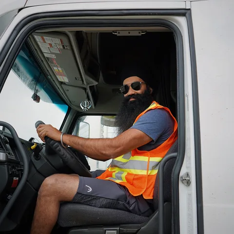 A commercial vehicle driver with their truck
