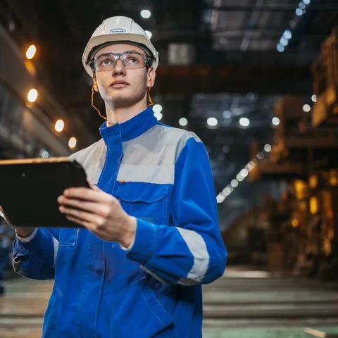 A site supervisor overseeing a factory floor