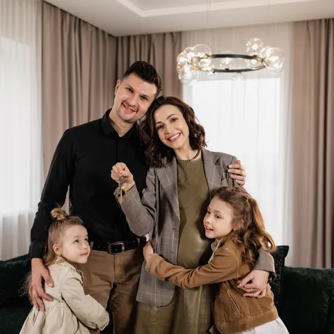 A family holding the keys to their new home