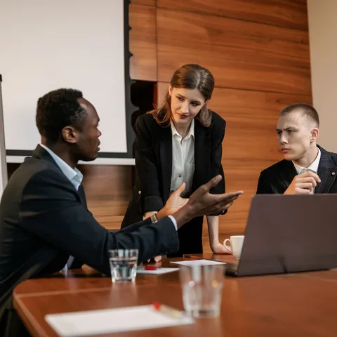 Professionals in a business risk discussion meeting